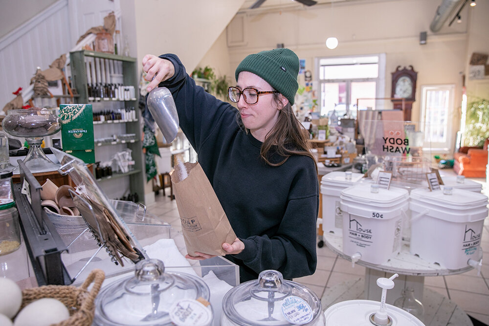 Manager Kori Smalley prepares a bag of the shop's sea salt to be weighed.