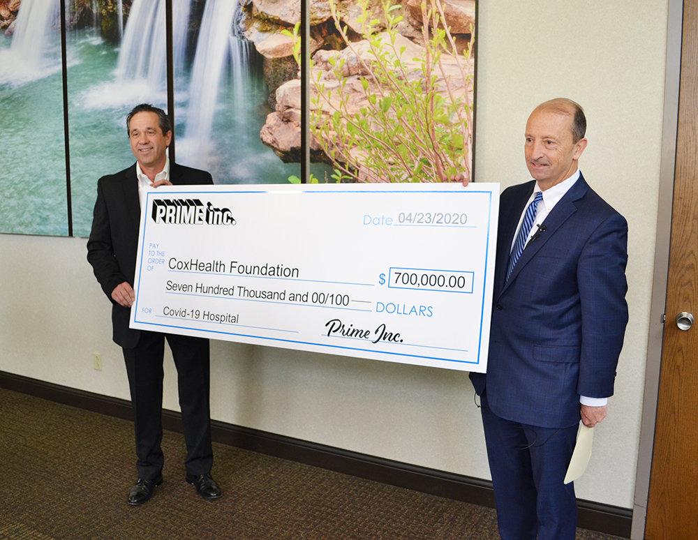 PRIME GIVING
Prime Inc. Controller Darrel Hopkins, at left, presents the trucking company’s $700,000 donation to CoxHealth and President and CEO Steve Edwards on April 23. The funds cover the remaining construction expenses of the hospital’s new COVID-19 unit at Cox South.